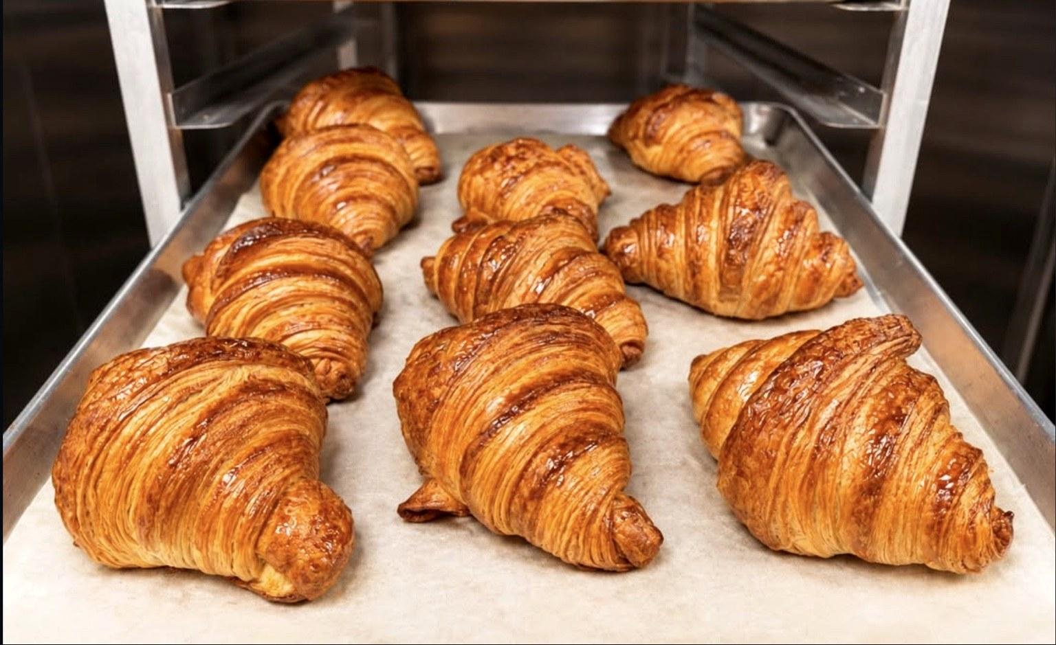 Fresh croissants on a baking tray at Tarte
